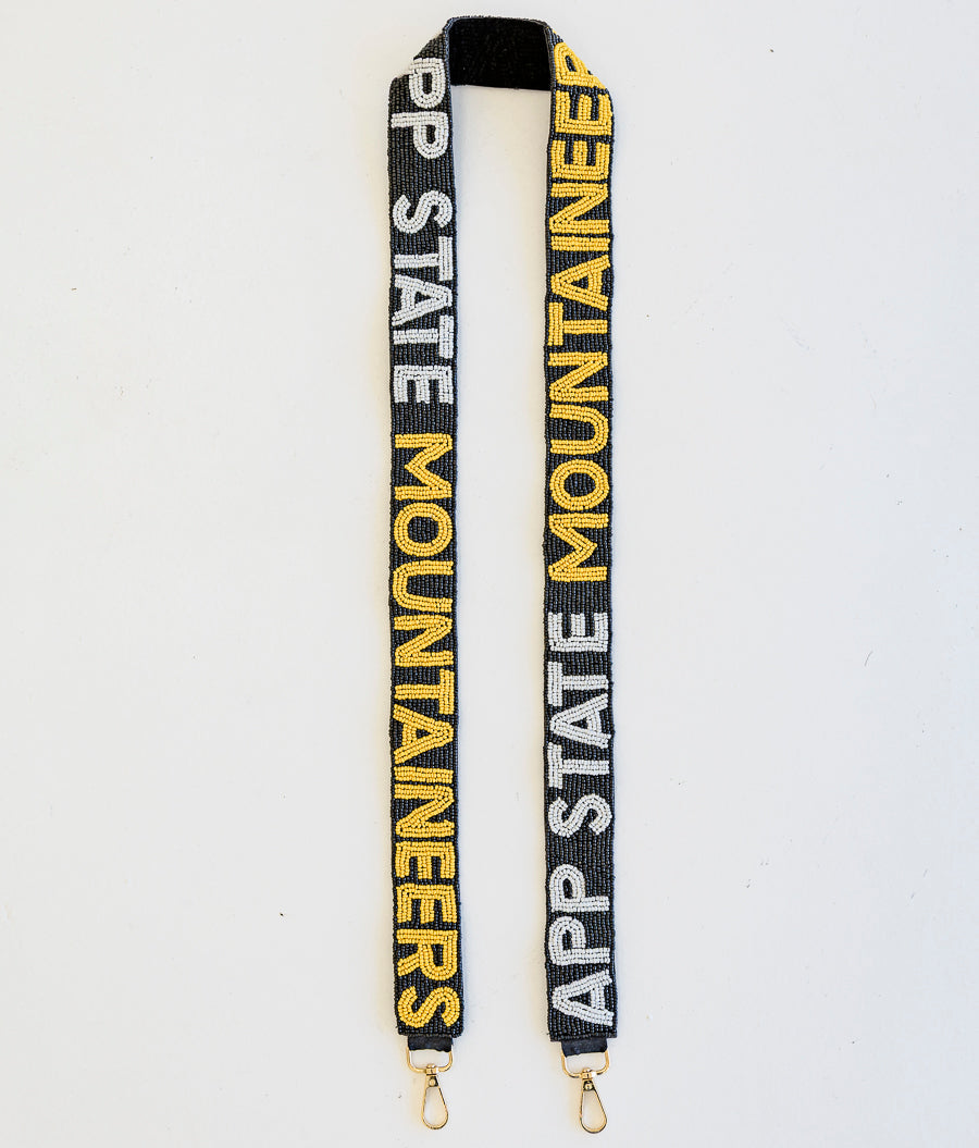 A beaded purse strap with App State Mountaineers in white and yellow on a black background.