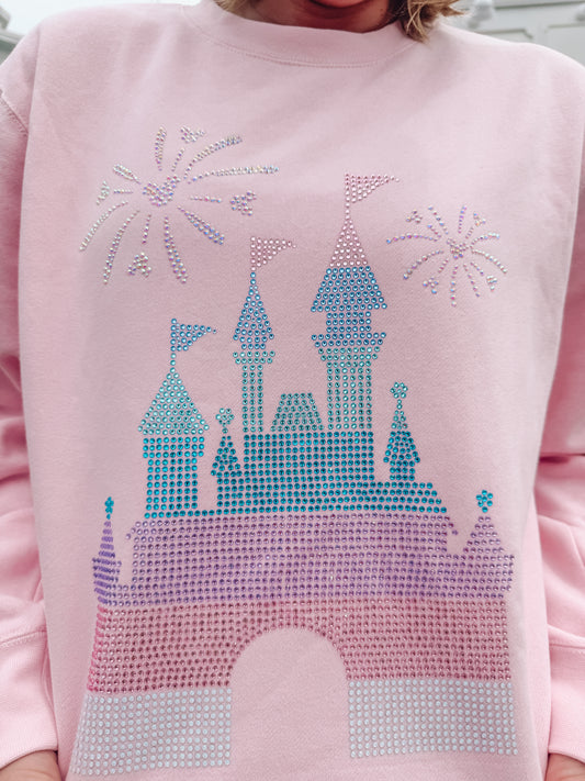 Pink sweatshirt with a castle design made of rhinestones on a light background