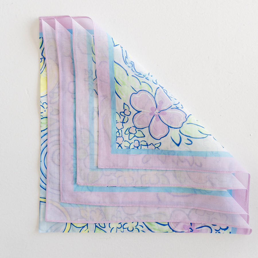 A floral scarf folded into loose fourths so each corner is visible.