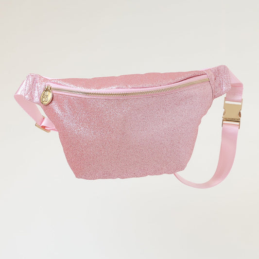 Pink fanny pack with gold zippers on a light gray background