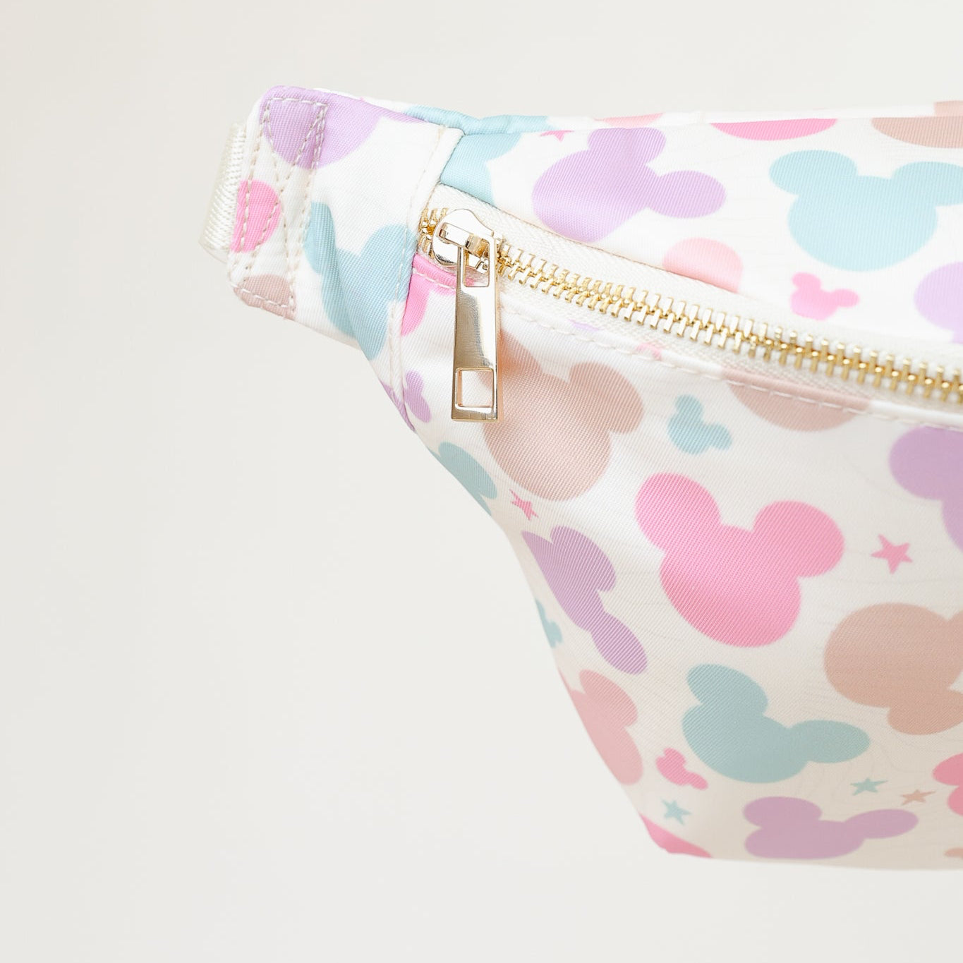 Fanny pack with pastel-colored mouse pattern head on a light background