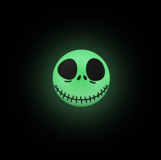 Glowing green skull face design on a black background